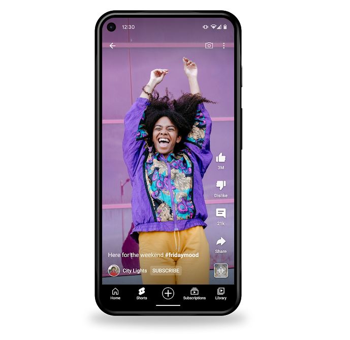 How To Make Youtube Shorts in Australia & New Zealand: A photo of a phone which is currently playing a YouTube short of a woman in a purpose jacket jumping up with her hands in the air